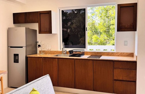 Tulum Condo | A Modern and cozy apartment in Ameli Tulum, surrounded by nature in Region 15. Enjoy the pool, peaceful common areas, and a stylish space designed for relaxation. Perfect for couples or travelers seeking comfort and a chic Tulum experience.
