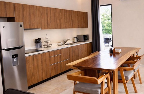 Tulum Condo | Escape to Giada Towers, Aldea Zama: 2-bedroom, 2-bathroom apartment with a private jacuzzi on the main terrace and a large L-shaped terrace with a grill and direct access to the pool. Includes 2 bicycles and access to the gym, movie theater, and ck